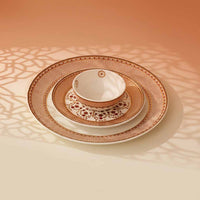 Set of ceramic plates with decorative patterns on a textured surface
