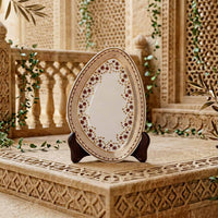 Decorative plate on a stand with intricate carvings in the background