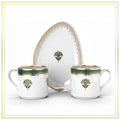 Set of ceramic dishes with green and gold floral patterns on a white background