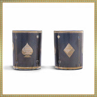 Two decorative candles with geometric patterns on a white background