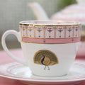pink and white cup and saucer