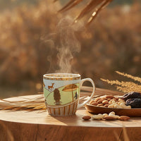 Steaming mug with a nature-themed design on a wooden table with nuts and dried fruits.
