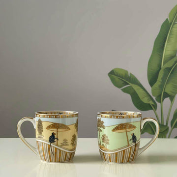 Two decorative mugs with artistic designs on a plain background