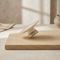 Decorative ceramic plate with intricate design on a wooden surface