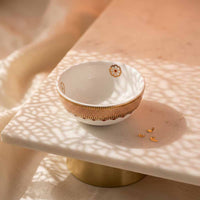 Decorative bowl with gold accents on a marble surface