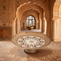 Decorative plate with intricate patterns on a pedestal in an ornate architectural setting