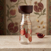 beautiful anaar design with gold print on bottle and wooden lid