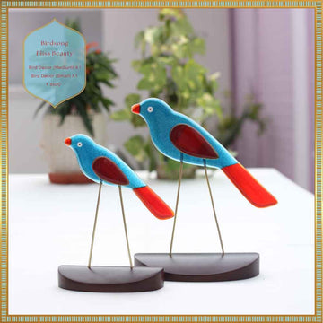 Two colorful bird figurines on stands with a blurred indoor background