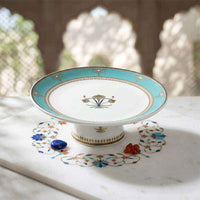 Decorative ceramic plate with intricate designs on a marble surface