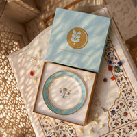 Decorative plate with a matching box on an ornate surface