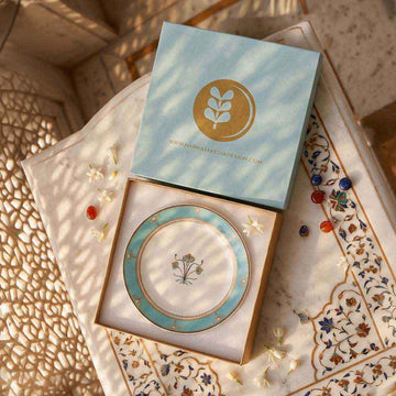 Decorative plate with a matching box on an ornate surface