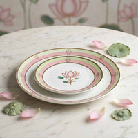 Set of ceramic plates with floral design on a marble surface with decorative elements.