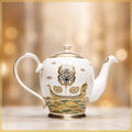 boat design golden tea pot in blurred background