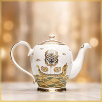 boat design golden tea pot in blurred background
