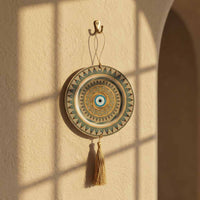 Decorative wall hanging with circular design and tassel on a beige wall.